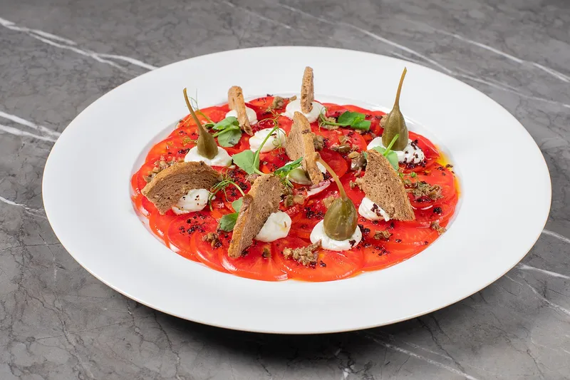 1 tomato carpaccio, goat cheese, Taggiasca olives & capers