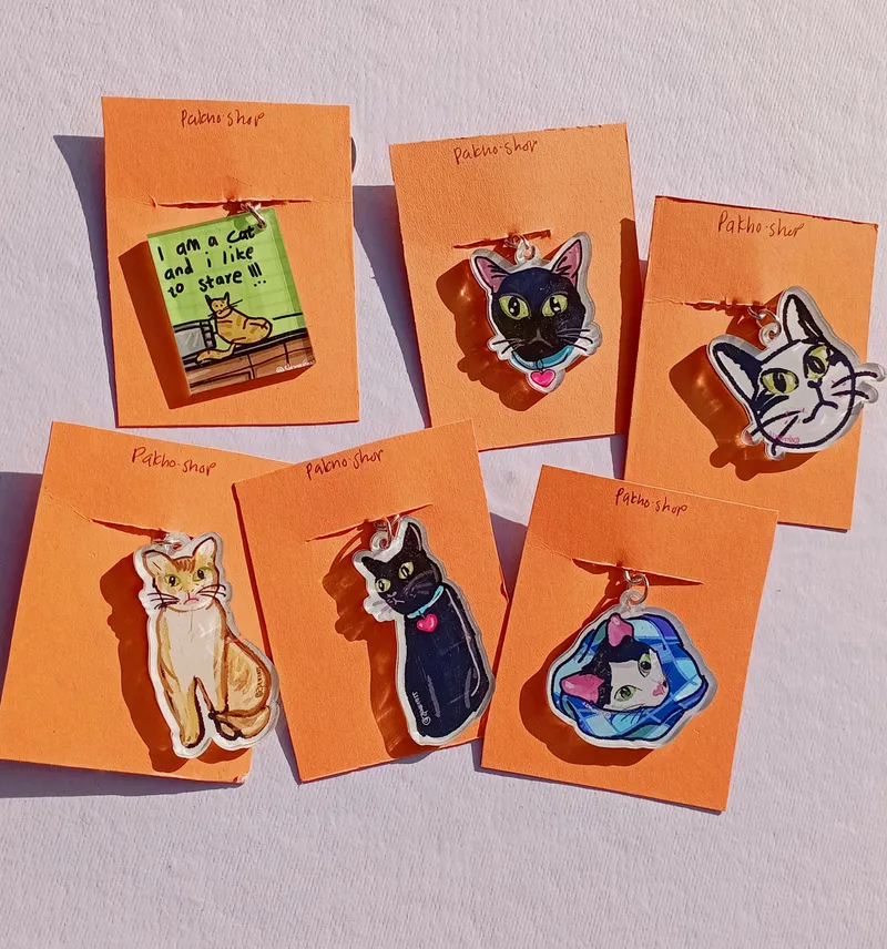 A collection of cute cat keychains with minimal packaging