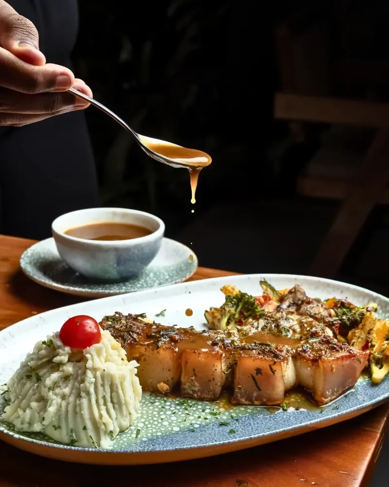 At Niche Bistro, our Pork Chop with Grilled Veggies and Mashed Potatoes is all about good vibes