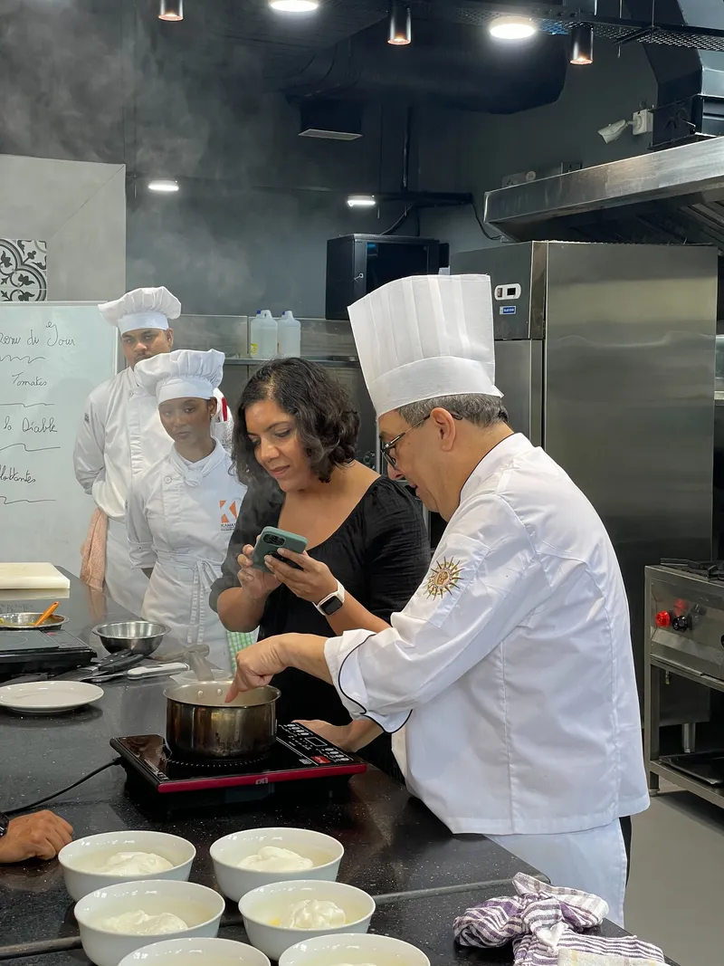 Chef Patrick Maitre Cuisinier de France and head chef faculty at the Verna based Kamaxi College of Culinary Arts KCCA guides a participant through a hands on French culinary Masterclass at KCCA. 1