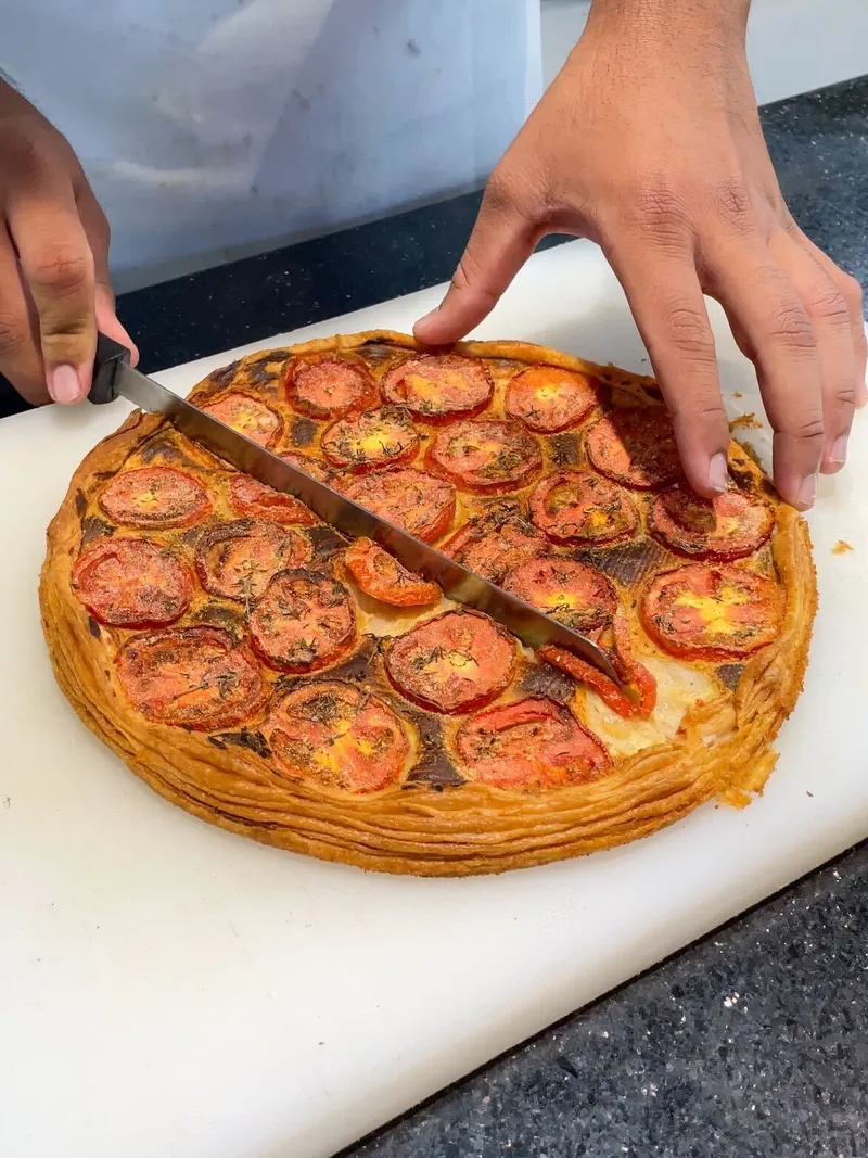 Chef Patrick, Maître Cuisinier de France and head chef faculty at the Verna-based Kamaxi College of Culinary Arts (KCCA) prepares to serve the tarte tomate (tomato tart) prepared during the French Masterclass (1)