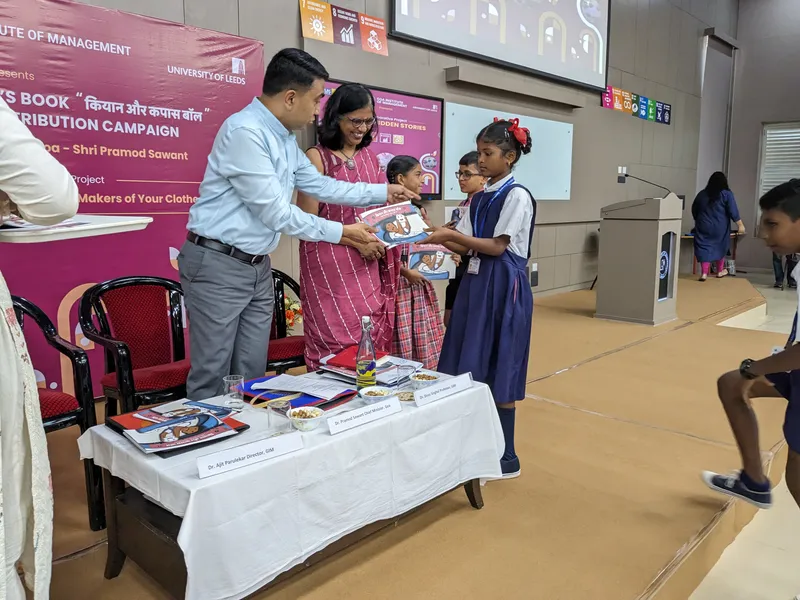 Goa Chief Minister Dr. Pramod Sawant distributing the book titled Kiaan aur Kapas Ball to students who attended the book launch at Goa Institute of Management campus in Sanquelim