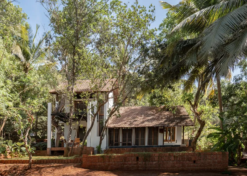 Guirim New Construction A compact 90 sqm home built without cutting trees designed around covered decks water bodies and verandahs to connect the interiors with nature