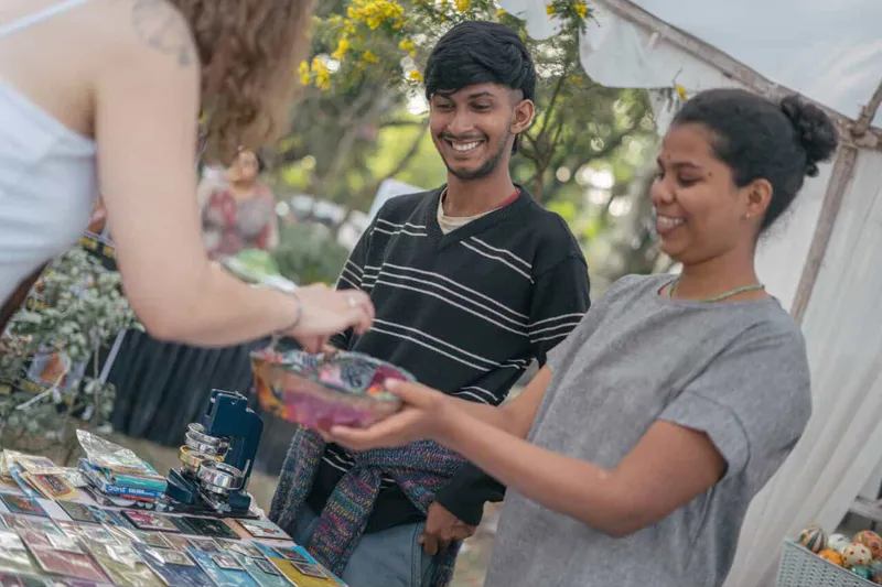 Joshua and Shravani interacting with customers at a pop-up market #3