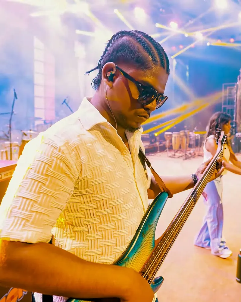 Oktoberfest style, performance ready — cornrows done for the guitarist