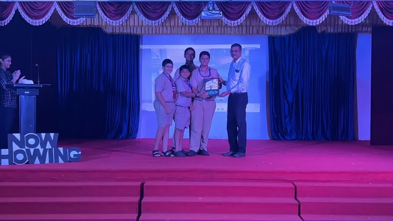 Prathit Fernandes and team being felicitated by College principal, Dr Cedric Silveira