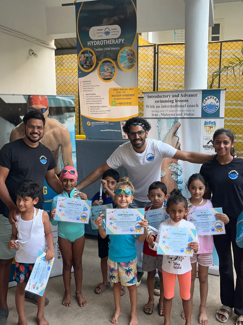 Team smiles with young swimmers 1