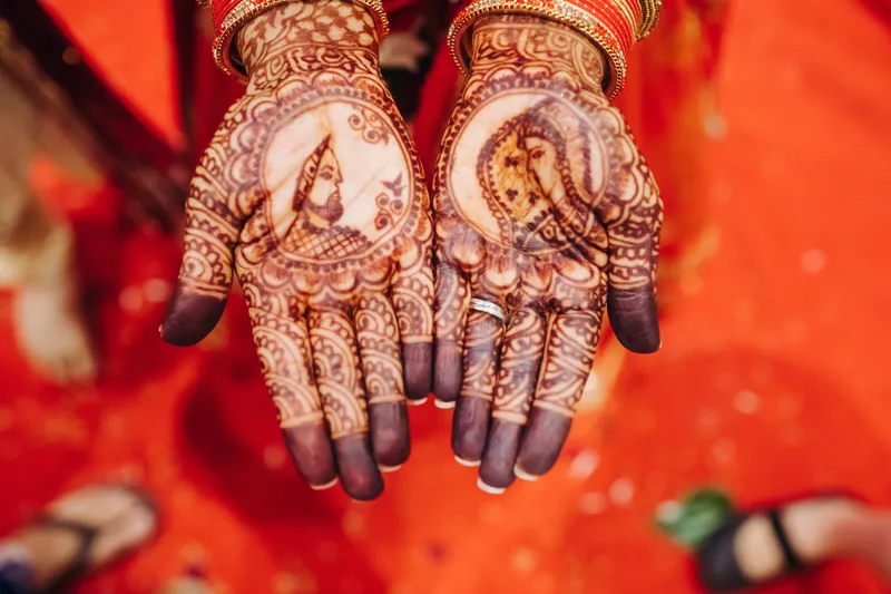 closeup hands pretty hindu bride with henna tattoo
