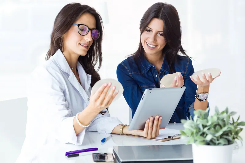 doctor her patient choosing mammary prosthesis office