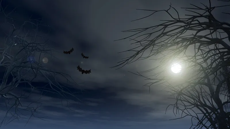 halloween background with spooky trees against moonlit sky