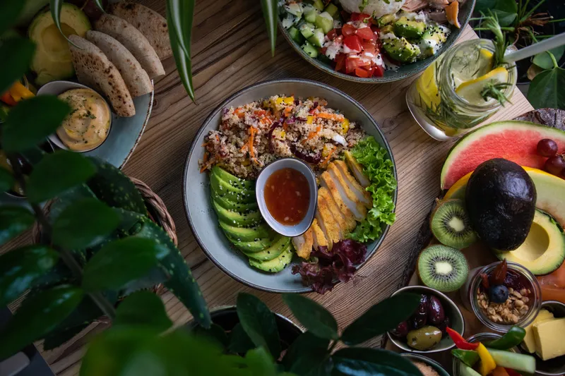 high angle shot plates salad fresh fruits vegetable wooden surface