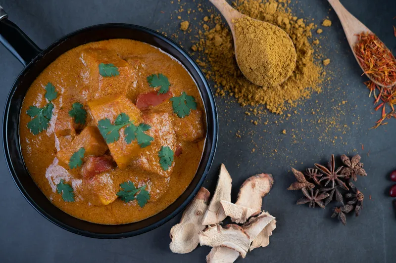 massaman curry frying pan with spices cement floor