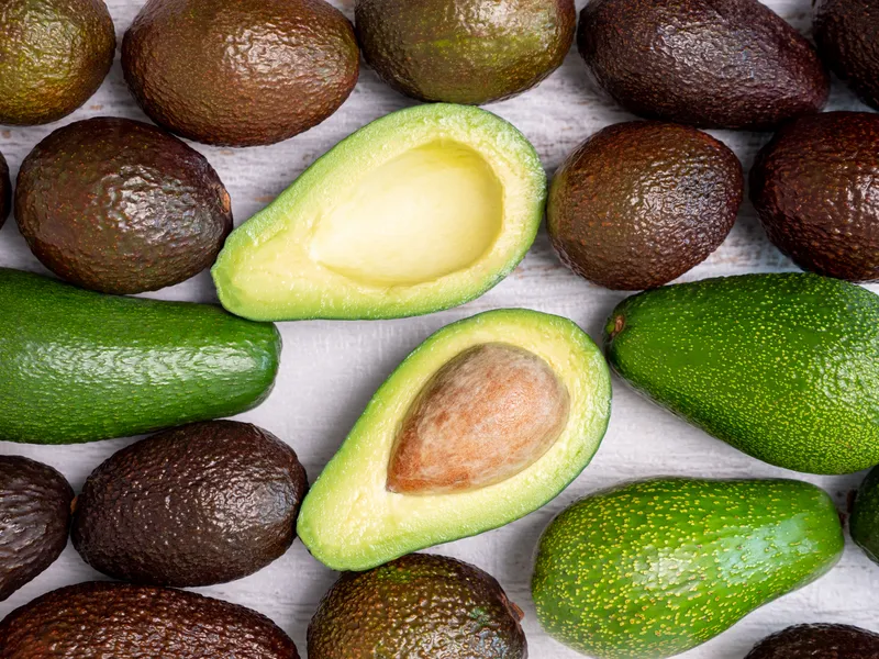 mix ripped green avocados white wooden board