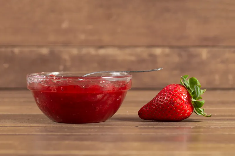 wooden surface with strawberry strawberry jam